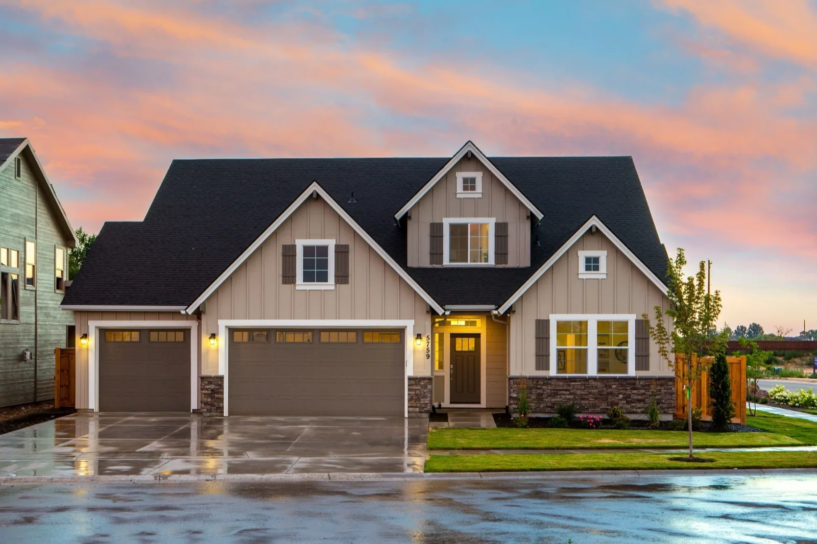 A house lit at dusk on a suburban street in Mississippi