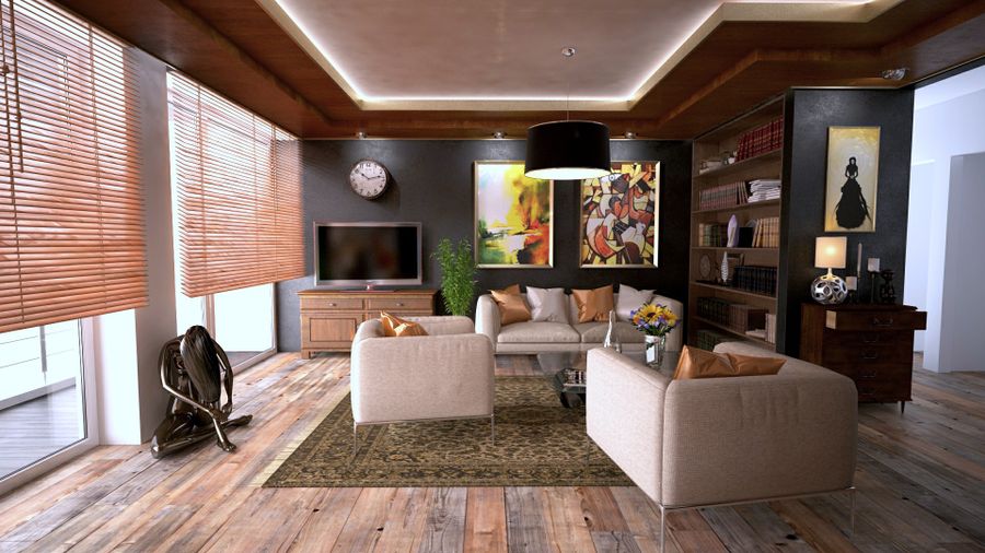 A living room with a wall-mounted television and built-in shelving